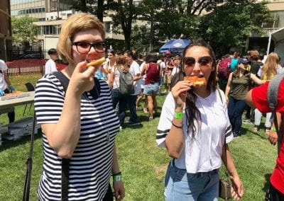 Two woman eating pizza
